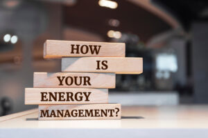 A stack of wooden blocks spelling "how is your energy management?